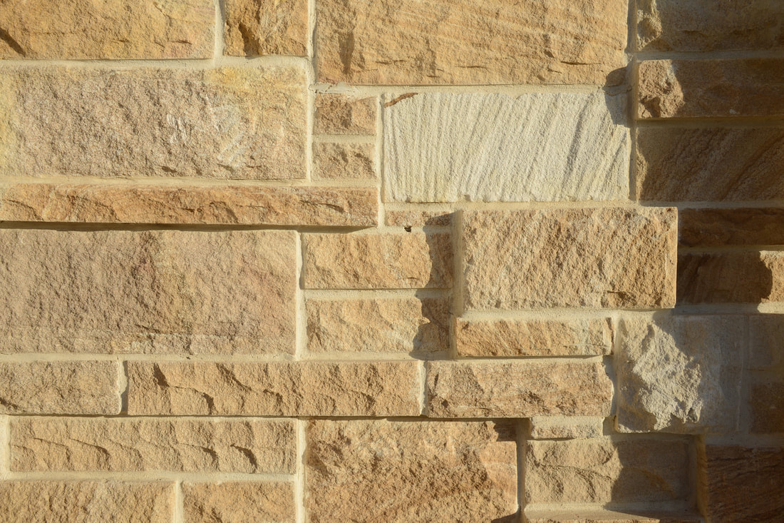 Handcrafted sandstone wall designed for early learning centre by Melbourne based architect